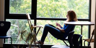 woman reading by window