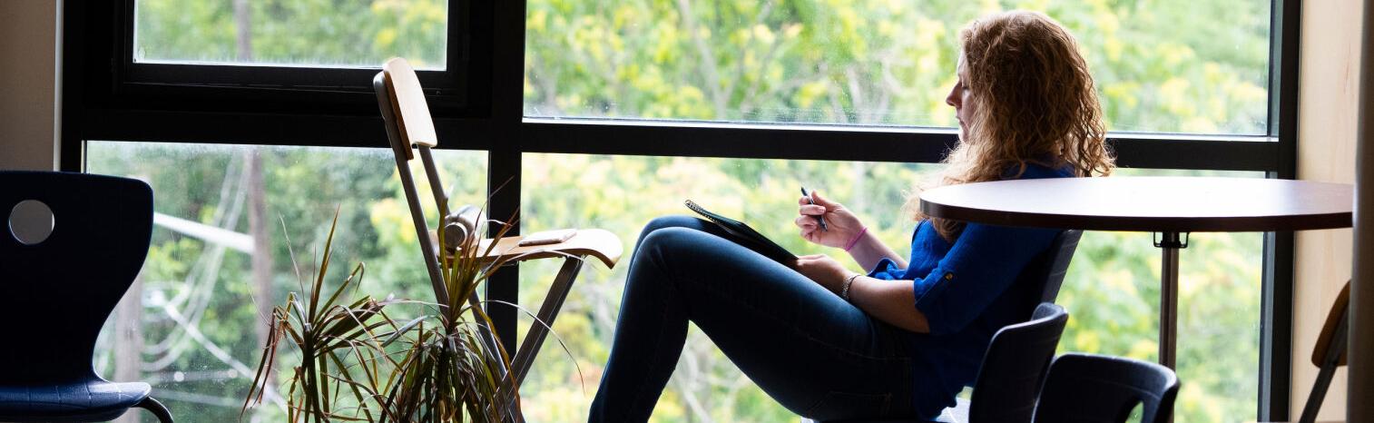 woman reading by window