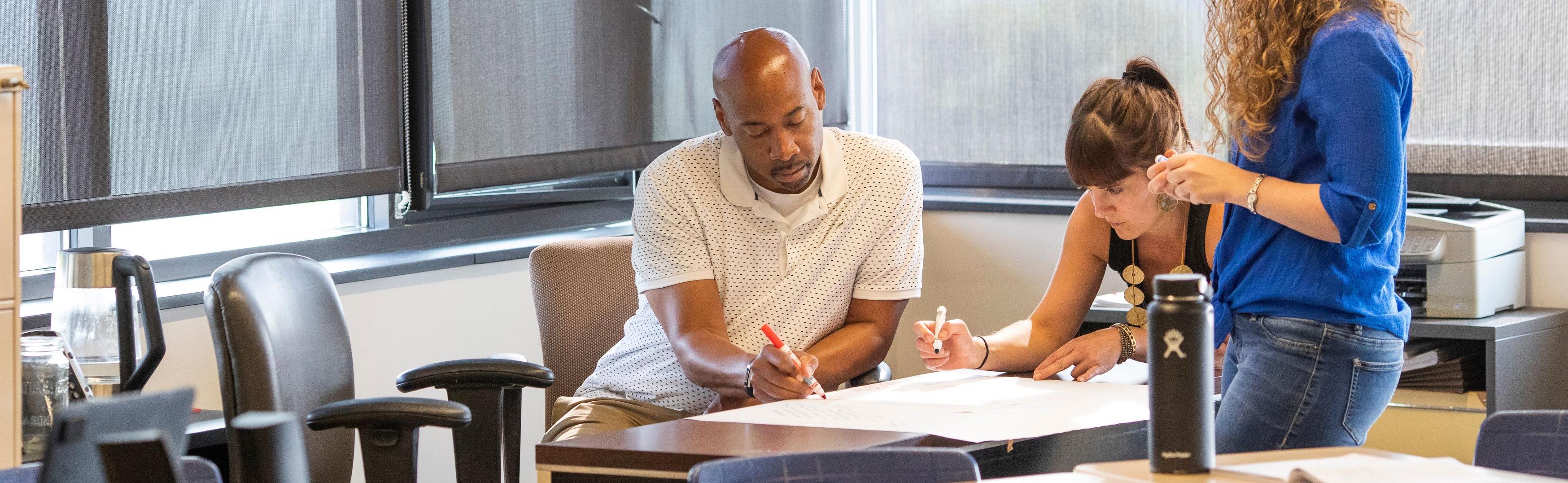 Teachers write at desk